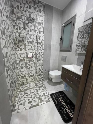 a bathroom with a toilet and a sink at villa avec piscine sans vis a vis in Temlale
