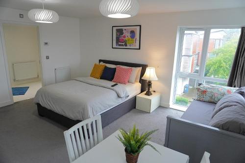 a bedroom with a bed and a window at Rylance Luxury House - Free Parking in Manchester