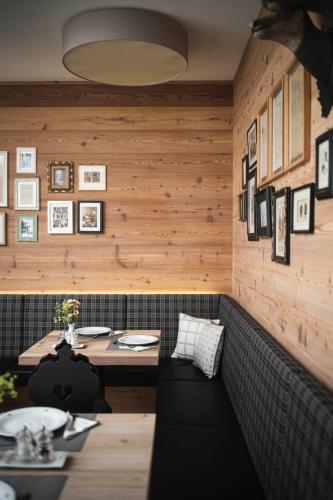 a dining room with wooden walls and a table at Christophorus Mountain Residence in San Vigilio Di Marebbe
