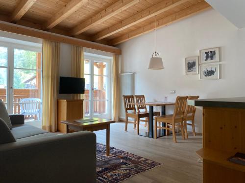 a living room with a couch and a table at Christophorus Mountain Residence in San Vigilio Di Marebbe