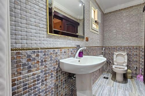a bathroom with a sink and a toilet at Comfy 2 Bedrooms Apartment in Cairo 92 in Cairo