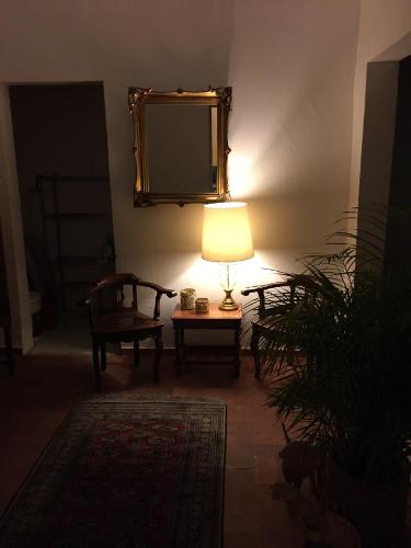 a room with a lamp and a chair and a mirror at Casa Molcajete in Mexico City