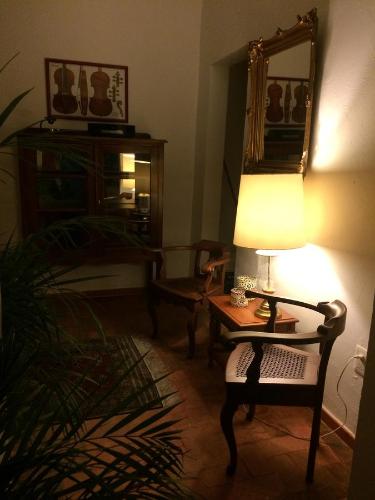 a living room with a table with a lamp and a chair at Casa Molcajete in Mexico City