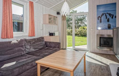 a living room with a couch and a table at Friedrichskoog-Deichblick 6 in Friedrichskoog