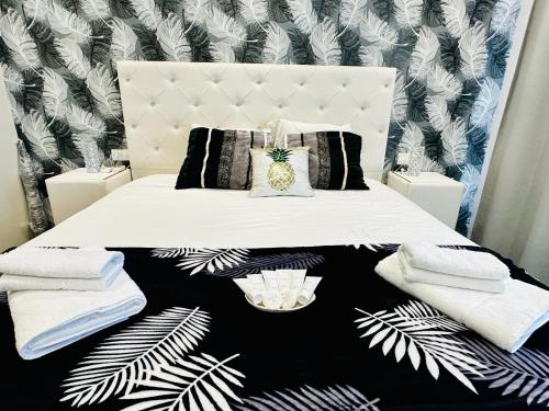 a bedroom with a white bed with towels on it at Luxury Villa LAPIS LAZULI in Meneou