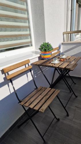 two chairs and a picnic table on a balcony at Apart Harmony in Ruse