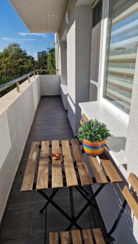 a balcony with a wooden bench on a building at Apart Harmony in Ruse