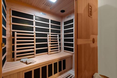 a sauna with wooden shutters in a room at Cosy Lake Paradise 4-Bed Retreat Pet Friendly in Rothesay