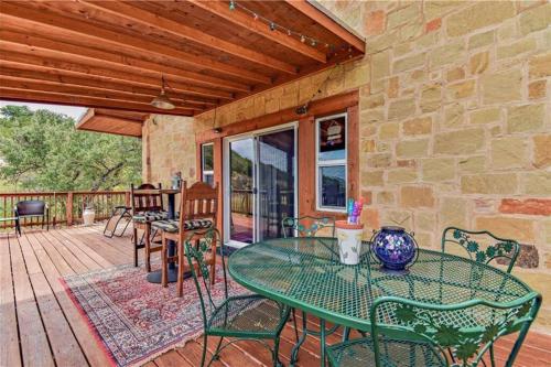 a patio with a table and chairs on a deck at RUSTIC BLUEBONNET CABIN With VIEW BY HIDDEN FALL PARK in Marble Falls
