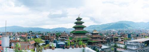 a view of a city with mountains in the background at Golden Gate Guest House in Bhaktapur