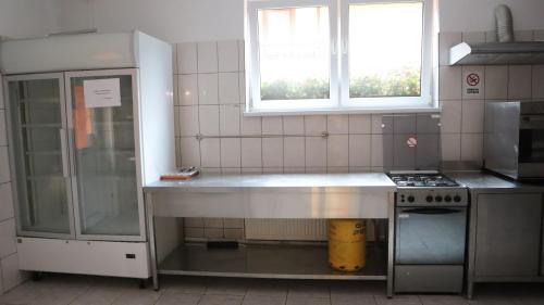 a kitchen with a stainless steel counter in it at Marginimea Sibiului - Pensiunea Darian & David in Orlat