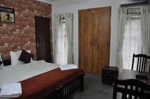 Postel nebo postele na pokoji v ubytování Banyan Tree Homestay