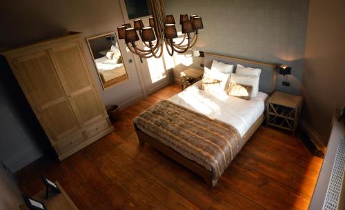 a bedroom with a large bed and a mirror at Chateau Beausaint in La-Roche-en-Ardenne