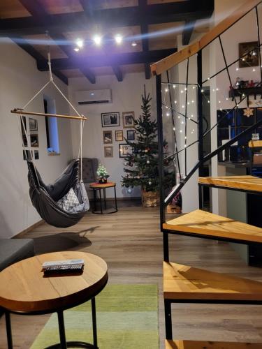 a room with a hammock and a christmas tree at HUUT in Zlatibor