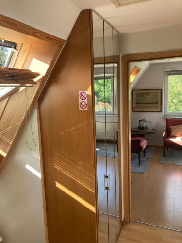 a hallway with a sliding door in a house at Privatzimmer am Volkspark - Nähe Arenen und Trabrennbahn in Hamburg