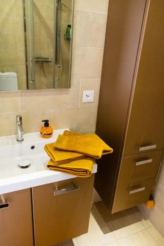 a bathroom with a sink and a shower and towels at Yellow House - Lugano in Lugano
