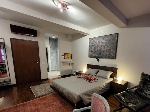 a bedroom with a bed and a chair in it at Le Cœur Urban Suite Parma in Parma