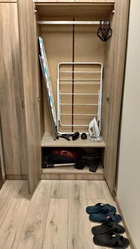 a room with a shelf with skis and a rack at Apart Harmony in Ruse