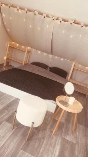 - un lit dans une tente avec une table et une chaise dans l'établissement Duplex escalier pliant, à Grez-sur-Loing