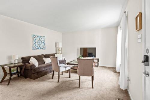 a living room with a couch and a table and chairs at Prime Location 2 BR Oasis with Washer and Dryer in Spring Grove