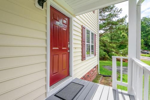 a red door on a house with a porch at Prime Location 2 BR Oasis with Washer and Dryer in Spring Grove