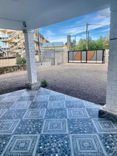 a patio with a tile floor and a gate at Villa Dei Niuri Mauritius in Pointe aux Piments