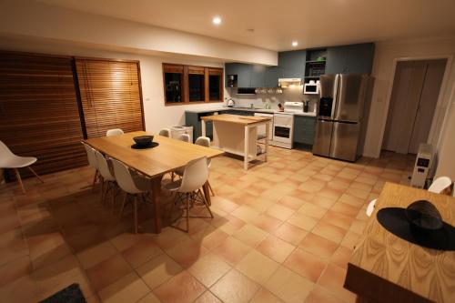 a kitchen and dining room with a table and chairs at Beachgum in Sunshine Bay