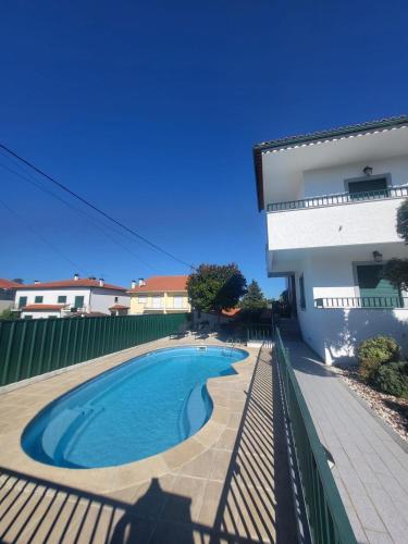a swimming pool in front of a building at Casa da Leonor in Viseu