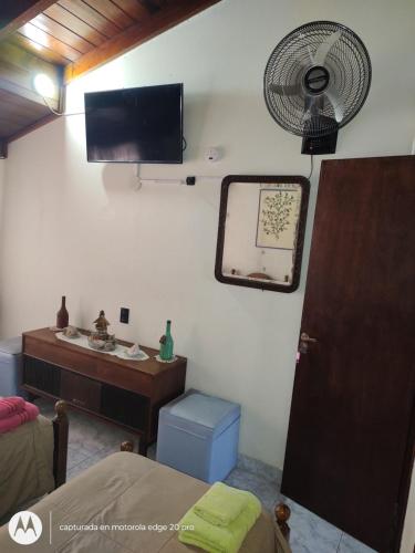 a room with a bed and a sink and a fan at Chalet residencial Maroli in Mar del Plata