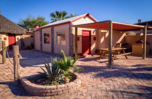 a building with a table and a picnic table in front of it at Beach Bungalow, Pool and direct Beach Access in San Felipe