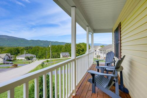a porch with two chairs and a view of a street at Charming Shenandoah Retreat with Deck! in Shenandoah