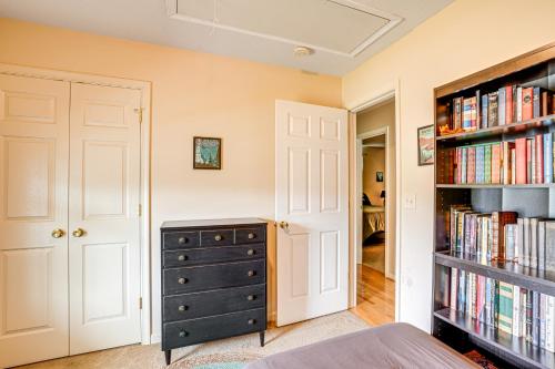 a bedroom with a dresser and a book shelf with books at Charming Shenandoah Retreat with Deck! in Shenandoah
