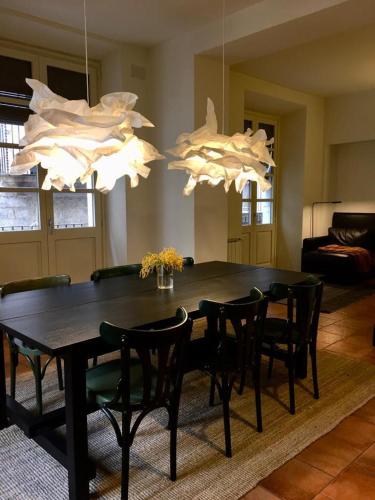 a dining room with a table and chairs and lights at Força Old Town in Girona