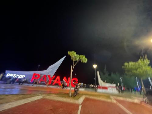 a skate park with a playasy sign at night at Eyka Studio Roomstay in Marang
