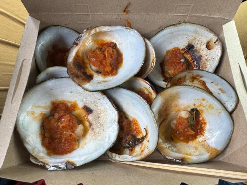 a box full of oysters with sauce on them at Eyka Studio Roomstay in Marang