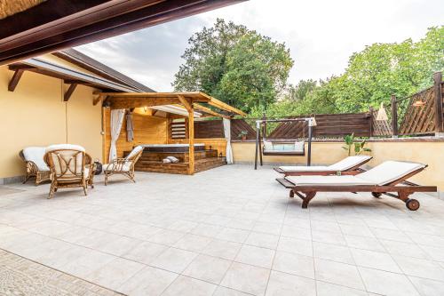 a patio with chairs and a table and a deck at Copper House in Lanciano