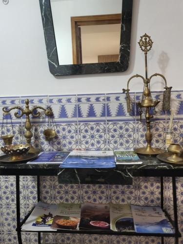 a counter with some plates of food and a mirror at Apartamento La Avenida in Lanjarón