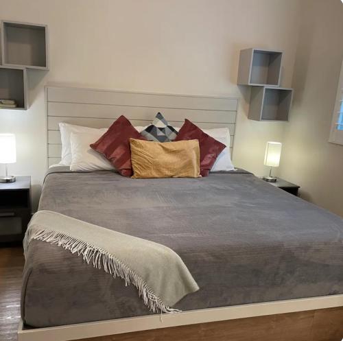 a bedroom with a large bed with many pillows at Sunset Hideaway in West Bay