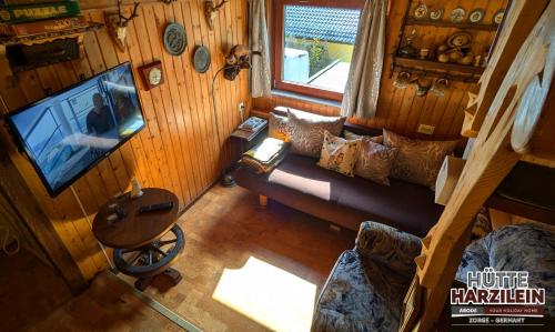 an overhead view of a living room with a couch and a television at Arode Hütte Harzilein - Romantic tiny house on the edge of the forest in Zorge