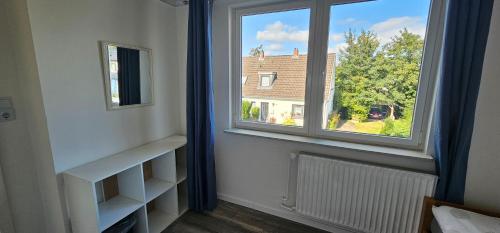 a room with a window with a view of a house at Ferienhaus "Dat Löppt" Bad Bramstedt in Bad Bramstedt