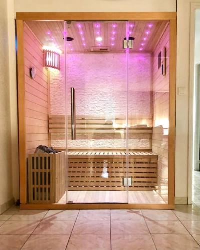 une chambre avec une porte vitrée avec douche dans l'établissement Grand appartement avec sauna, à Strasbourg