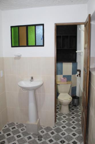 a bathroom with a sink and a toilet at Hostel Mirador Aukán in Bogotá
