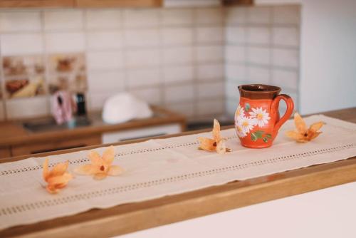 a coffee cup sitting on a counter with butterflies on it at Casa Bunicilor in Nucşoara