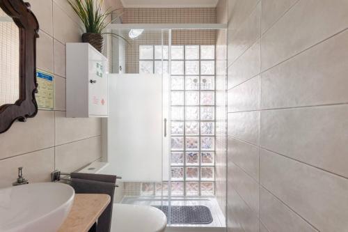 a bathroom with a white sink and a window at Estudio T41 - Downtown Lisbon Historic Center in Lisbon
