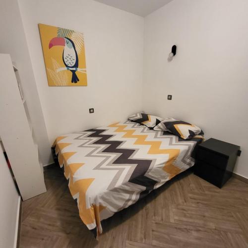 a bedroom with a bed and a painting on the wall at Sunset Apartment in Playa del Ingles