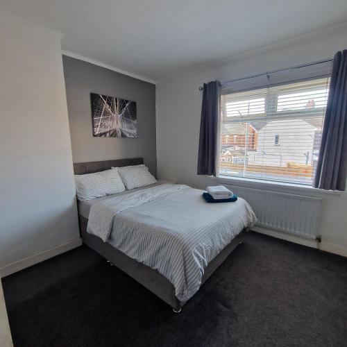 a bedroom with a bed and a window at Belfast City house in Belfast