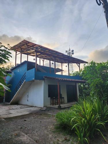 a small house with a roof on top of it at Alma Del Bosque Hotel in Tortuguero