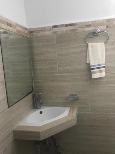 a bathroom with a sink and a mirror at Villa Lulu in Chicxulub