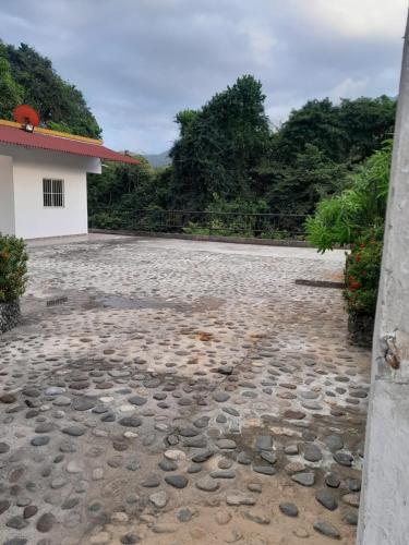 a stone driveway in front of a house at Casa turística rio piedra in El Zaino