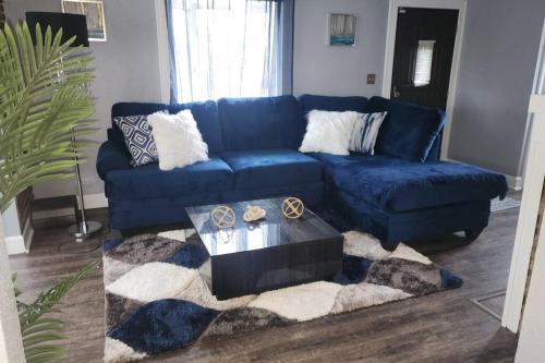 a living room with a blue couch and a table at Charming Spacious and Affordable Gem of Parma in Parma